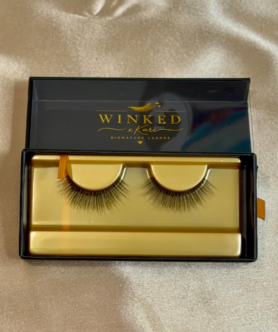 Darling signature lashes on a gold tray inside an open black box